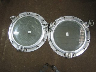 A pair of circular white metal port holes 19"