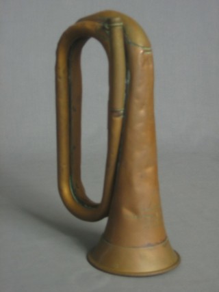 A copper and brass bugle marked supplied by Busey & Hawkes Cape Town