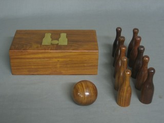 A hardwood indoor skittle game contained in a wooden box 10" 