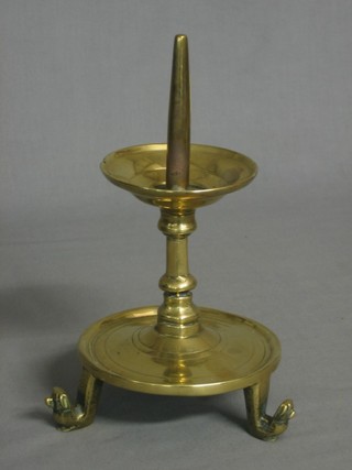 A brass pricket candlestick raised on 3 hoof supports 9"