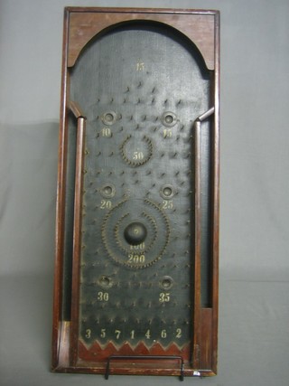A wooden bagatelle game