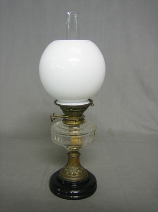 A 19th Century glass oil lamp reservoir with opaque glass shade and gilt metal base