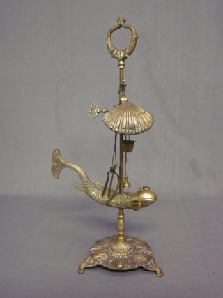 A 19th Century Continental brass oil lamp in the form of a dolphin 22"