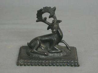 A 19th Century bronze paperweight in the form of a seated Stag 3 1/2"