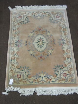 A peach ground and floral patterned Chinese carpet 73" x 48"