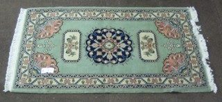 A contemporary green ground Shiraz rug with central medallion 58" x 41"
