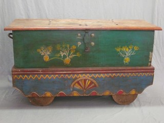 An Eastern painted hardwood trunk with hinged lid, raised on rollers 59"