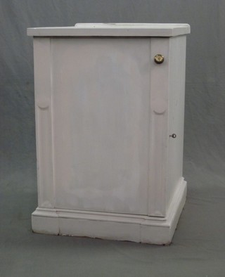 A white painted mahogany pedestal cabinet enclosed by a panelled door, raised on a platform base 24"