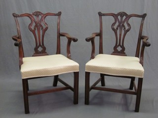 A pair of Chippendale style mahogany carver chairs with vase shaped slat backs and upholstered drop in seats