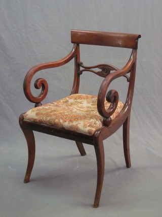 A 19th Century mahogany bar back carver chair with shaped mid rail and upholstered drop in  seat, raised on sabre supports