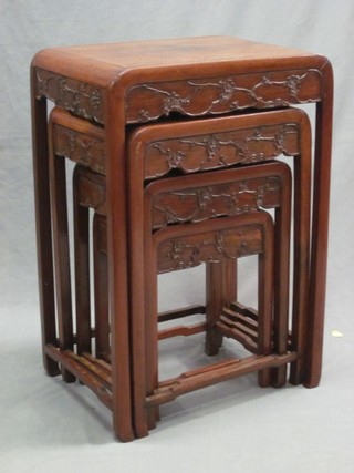 A nest of 4 Oriental carved Padouk interfitting coffee tables