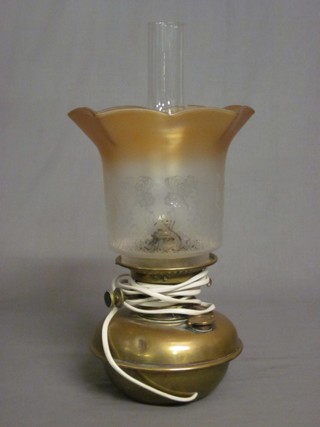 A Harrods brass oil lamp converted to an electric table lamp with brown etched glass shade