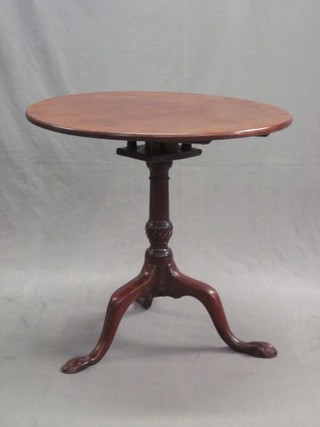 An 18th Century circular snap top tea table, with bird cage action, raised on a turned gun barrel column and tripod base 29"