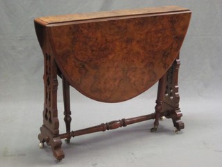 A Victorian oval figured walnut Sutherland table, raised on pierced standard end supports 34"