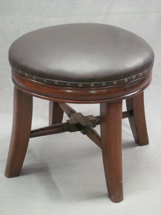 A 19th Century mahogany revolving stool, raised on outswept supports with X framed stretcher 19"