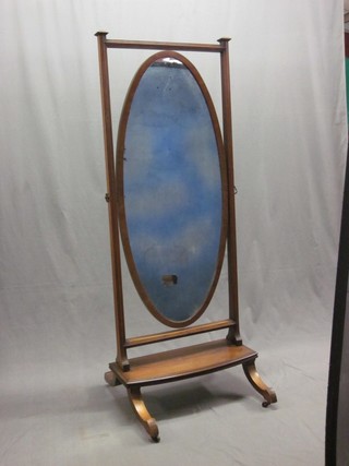 A 19th Century oval plate cheval mirror contained in a mahogany swing frame