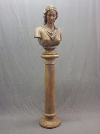 A reproduction Victorian terracotta head and shoulders portrait bust of a classical lady, raised on a column 25"