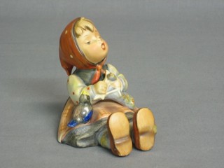 A Hummel figure of a seated girl knitting and with a bird 4"