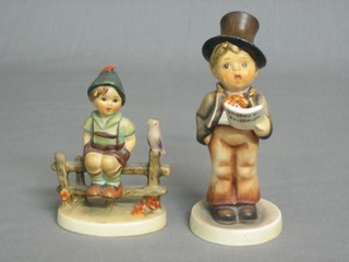 A Hummel figure of a seated boy on a stile with a bird 3", together with 1 other standing boy (head f and r)