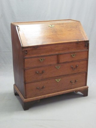 An 18th Century honey oak bureau, the fall front revealing a  well and with fitted interior above 2 short and 2 long drawers, raised on bracket feet 33"