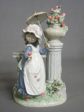 A Lladro figure of a girl with parasol by a floral pedestal with rose 11" (rose f and r)