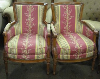 A pair of mahogany framed show frame tub back chairs upholstered in pink striped material