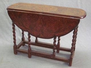 A Victorian oval shaped inlaid walnut Loo table converted for use as a drop flap table, raised on an oak spiral turned columns 36"