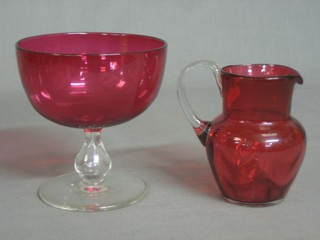 A 19th Century cranberry glass jug with clear glass handle 4" and a cranberry glass bowl with clear glass stem