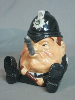 A humerous Staffordshire teapot in the form of a seated Police Sargeant 8"