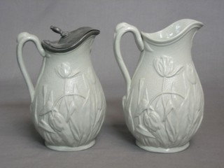 2 19th Century grey salt glazed jugs with floral embossed decoration 7"