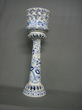 A pierced blue and white pottery jardiniere on stand