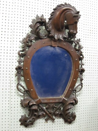 A horse shoe shaped mirror contained in a carved wooden frame surmounted by a figure of a horse 29" overall