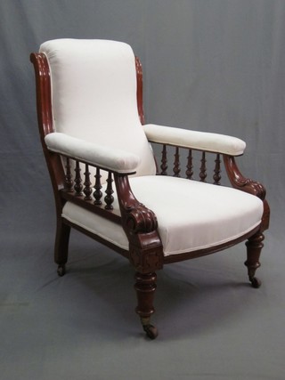 A Victorian mahogany armchair with bobbin turned  decoration and upholstered seat and back, raised on turned supports