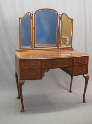 A Queen Anne style walnut and crossbanded dressing table with triple mirror over, the base fitted 1 long drawer flanked by 4 short drawers, raised on cabriole ball and claw supports 42"