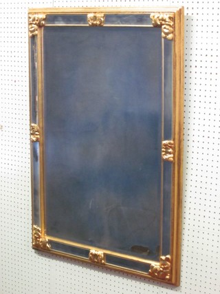 A rectangular bevelled plate wall mirror contained in a gilt frame 38" x 27"