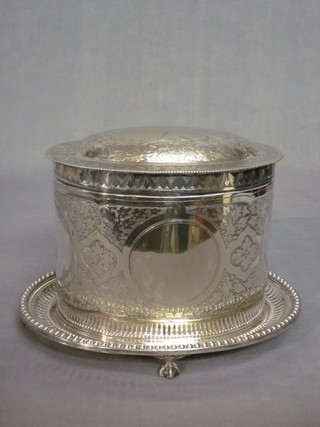 An oval engraved silver plated biscuit barrel with hinged lid