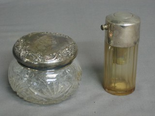 A circular faceted glass perfume atomiser together with a circular cut glass dressing table jar with embossed silver lid