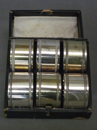 6 silver plated napkin rings with bead work borders, cased