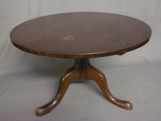 A circular mahogany tea table raised on a pillar and tripod base 31"