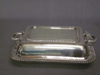 A rectangular twin handled silver plated entree dish and cover