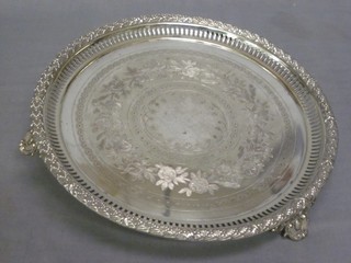 A circular engraved and pierced silver plated salver, raised on 3 panelled supports 10"