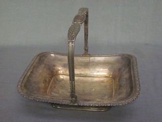 A 19th Century rectangular silver plated cake basket with swing handle, raised on a spreading foot 11"