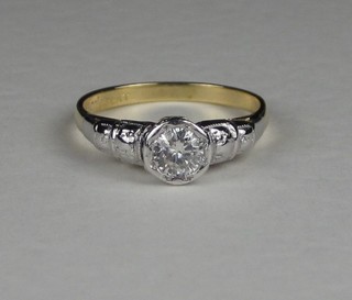 An 18ct yellow gold and platinum dress ring set a circular cut diamond