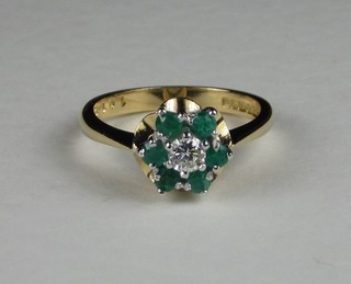 A 18ct gold cluster dress ring set emeralds and diamonds