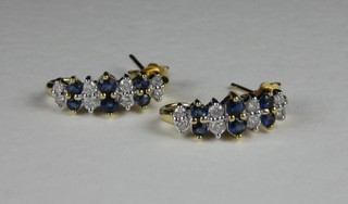 A pair of 18ct drop earrings set sapphires and diamonds