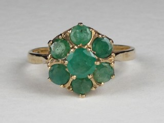 A  9ct gold cluster dress ring set emeralds