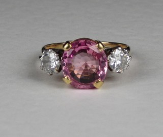 A lady's  18ct gold dress ring set a pink sapphire supported by 2 diamonds ILLUSTRATED