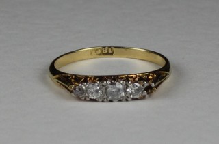 An 18ct gold dress ring set diamonds (1 stone missing)