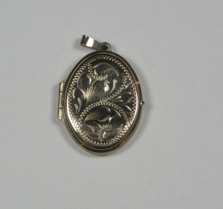 A 9ct gold oval engraved locket