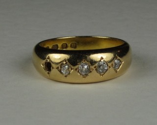 An 18ct gold dress ring set diamonds (1 missing)